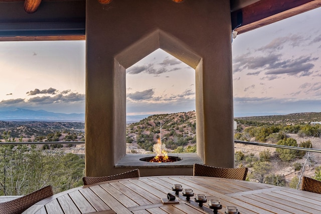 exterior space with a mountain view and a fire pit