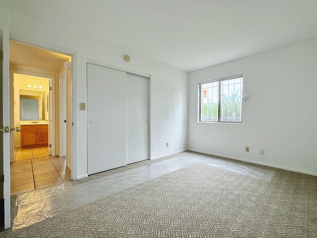 unfurnished bedroom featuring carpet floors and a closet