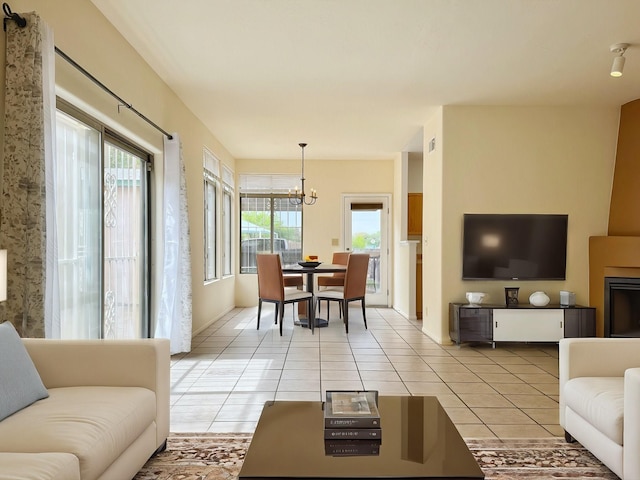 tiled living room featuring an inviting chandelier