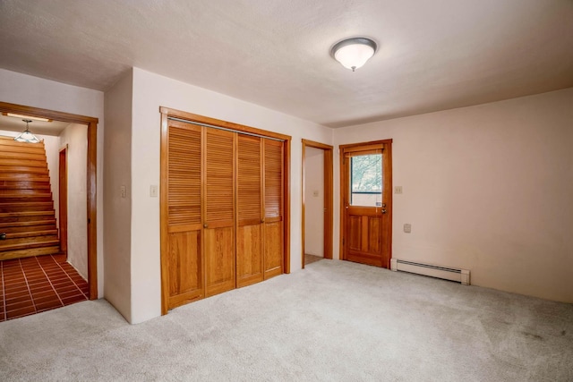 unfurnished bedroom featuring a baseboard radiator, carpet, and a closet