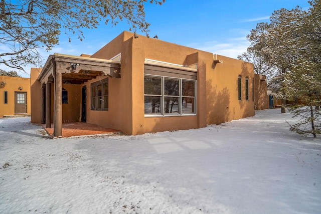 view of snow covered rear of property