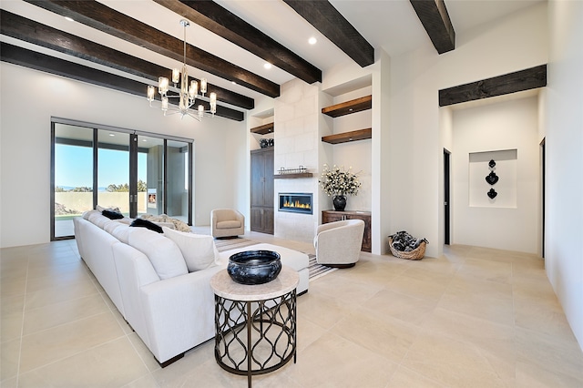 tiled living room with a tiled fireplace, beamed ceiling, a chandelier, and a high ceiling