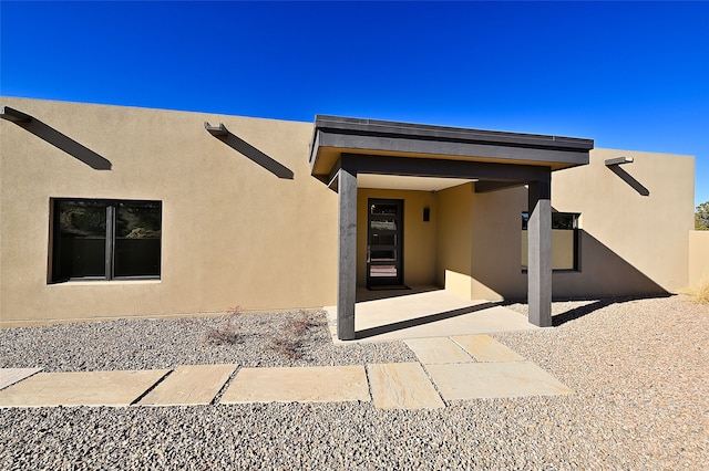 entrance to property with a patio