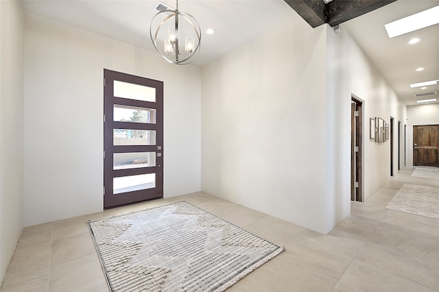 foyer featuring light tile patterned flooring and a chandelier