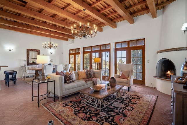 living room with an inviting chandelier, wood ceiling, a fireplace, and beamed ceiling