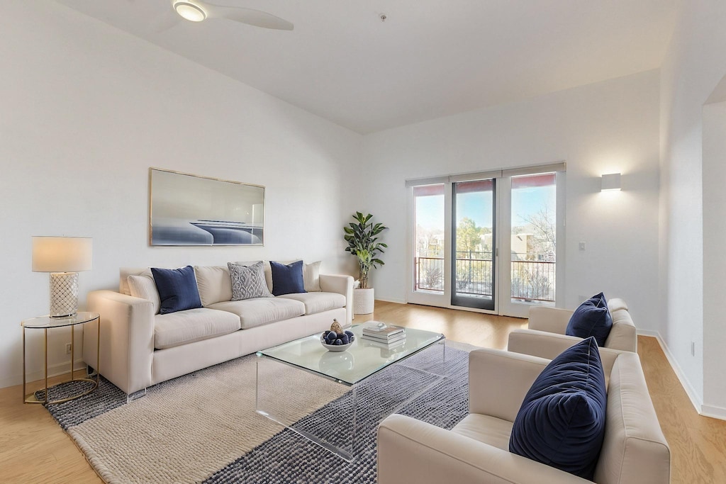 living room with light hardwood / wood-style floors and ceiling fan