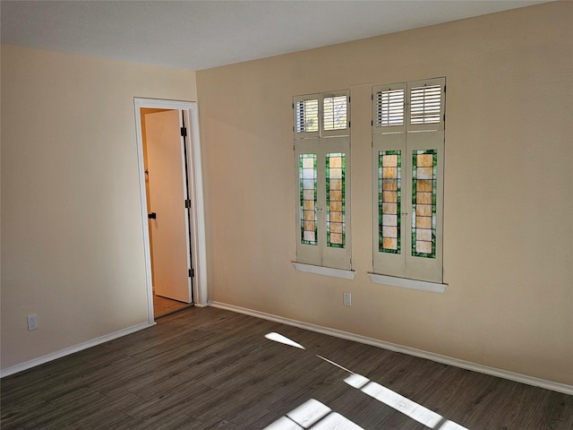 spare room with dark hardwood / wood-style flooring