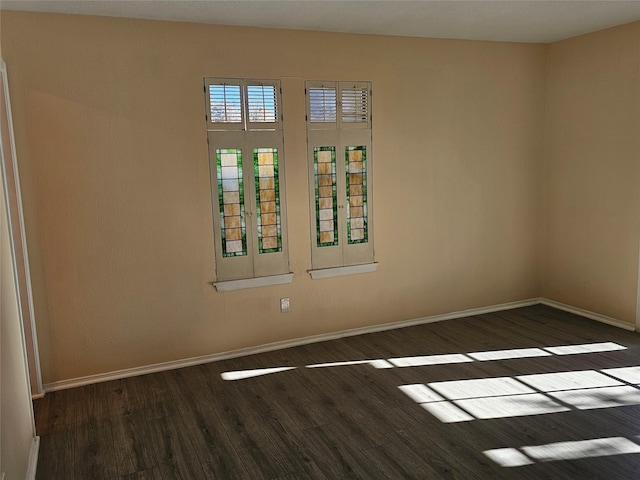 spare room with dark hardwood / wood-style flooring