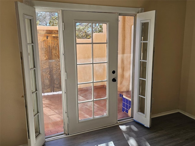 doorway to outside with dark hardwood / wood-style floors