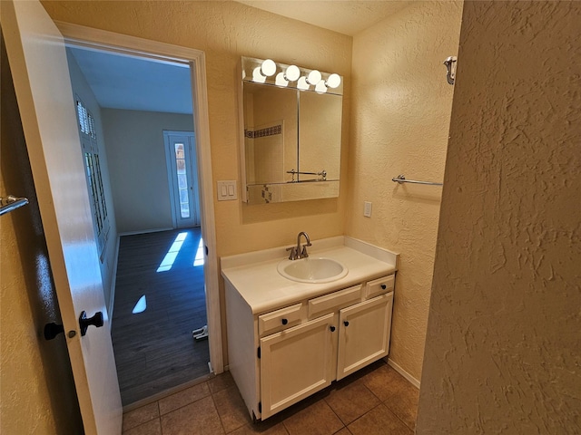 bathroom with tile patterned floors and vanity