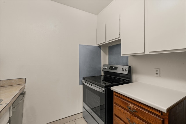 kitchen featuring white cabinetry, light tile patterned floors, and stainless steel appliances