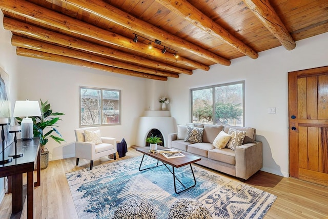 living room featuring wood ceiling, light wood-type flooring, and beamed ceiling