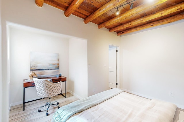 bedroom with beamed ceiling, light wood-type flooring, and wooden ceiling