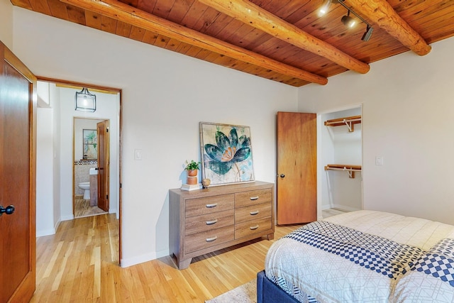 bedroom with wood ceiling, rail lighting, light hardwood / wood-style floors, and beamed ceiling