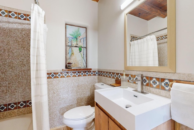 full bathroom with tile walls, vanity, shower / bath combination with curtain, and toilet