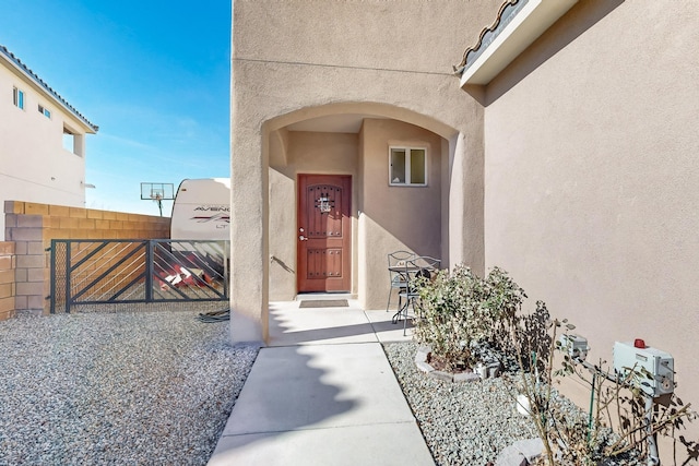 view of exterior entry featuring a patio area