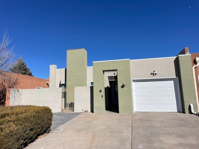 pueblo-style home with a garage