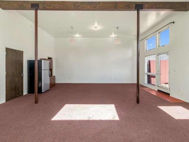 basement featuring carpet floors and freestanding refrigerator