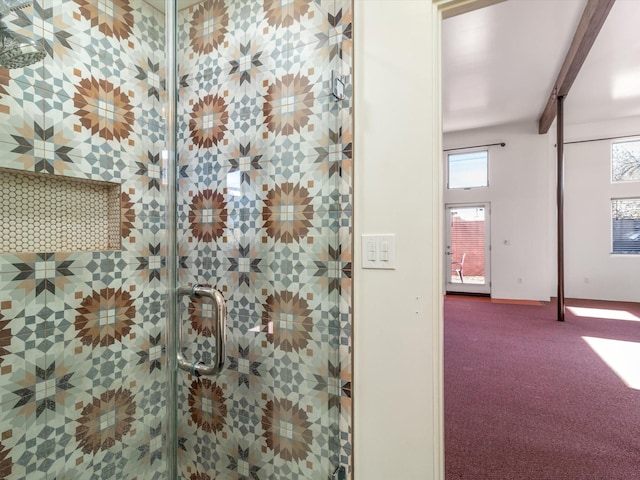 bathroom with beamed ceiling and a stall shower