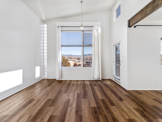 spare room featuring vaulted ceiling and wood finished floors