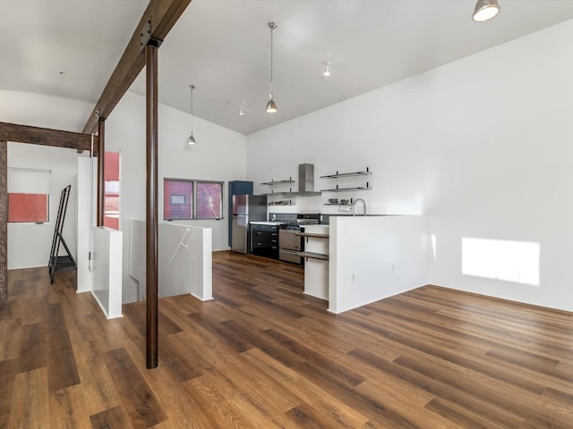 kitchen with extractor fan, lofted ceiling with beams, dark wood-style floors, stainless steel appliances, and a sink