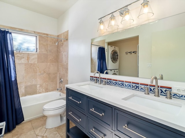 bathroom featuring a sink, shower / bathtub combination with curtain, double vanity, and stacked washing maching and dryer