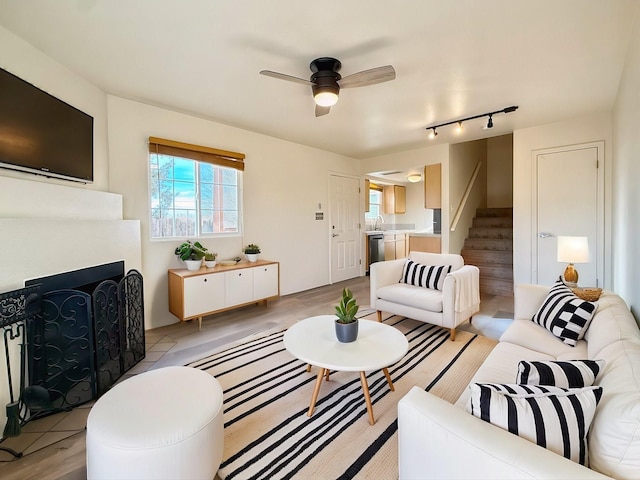 living room featuring sink and ceiling fan