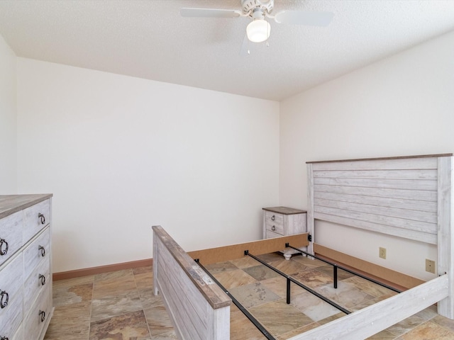 bedroom featuring ceiling fan and a textured ceiling