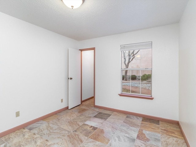 empty room with a textured ceiling