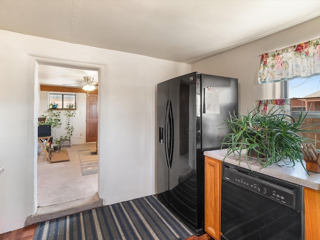 kitchen featuring ceiling fan, dark carpet, and black appliances