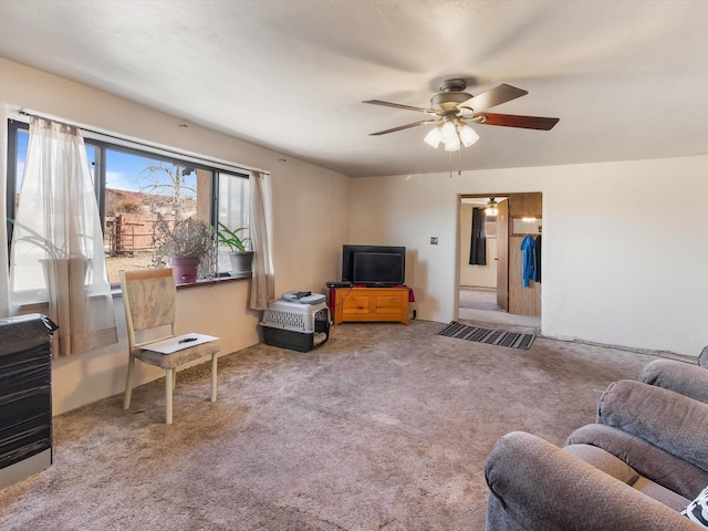 living room featuring ceiling fan and carpet floors