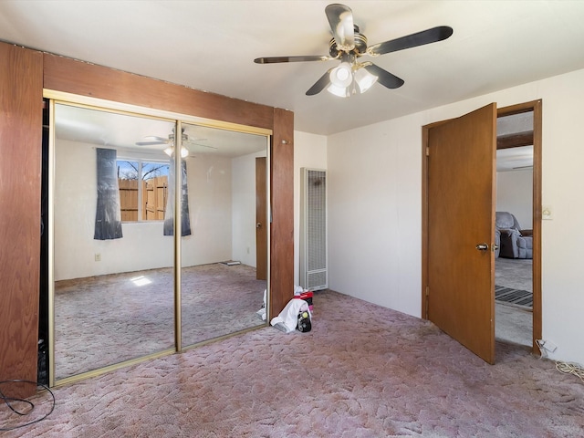 unfurnished bedroom with a closet, ceiling fan, and carpet flooring