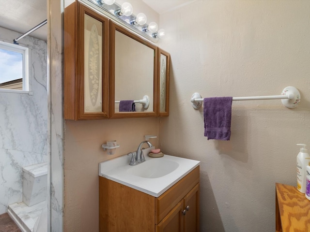 bathroom with vanity and a shower