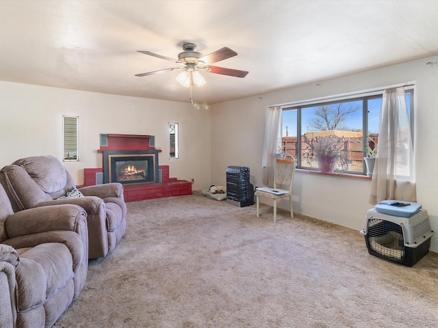 carpeted living room featuring ceiling fan