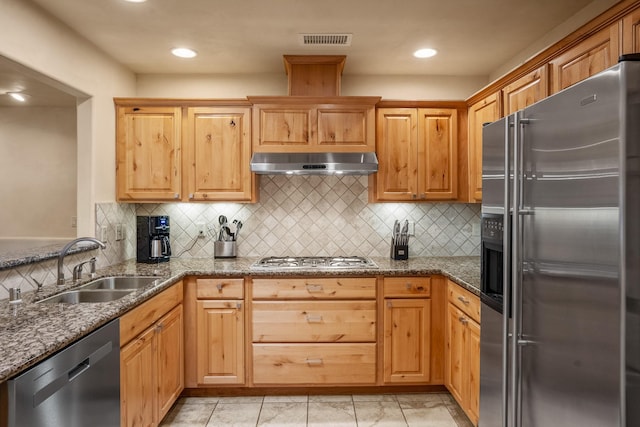 kitchen with tasteful backsplash, stainless steel appliances, sink, and dark stone counters