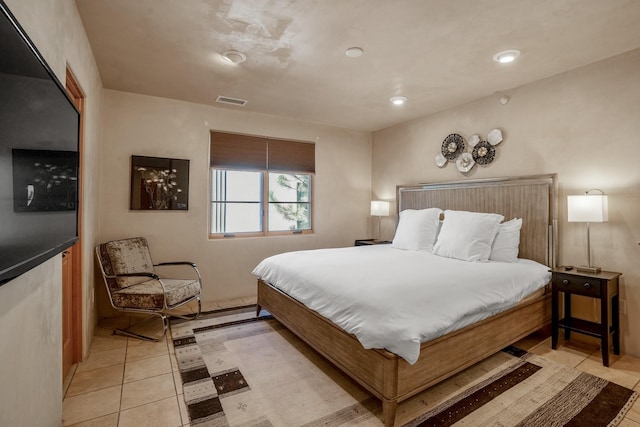 bedroom with light tile patterned floors