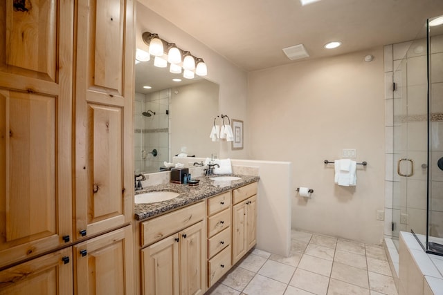 bathroom featuring tile patterned flooring, vanity, and a shower with shower door