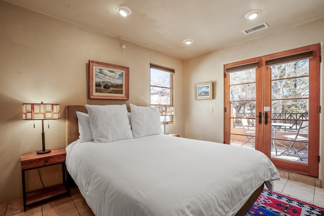 bedroom with french doors, light tile patterned floors, and access to outside