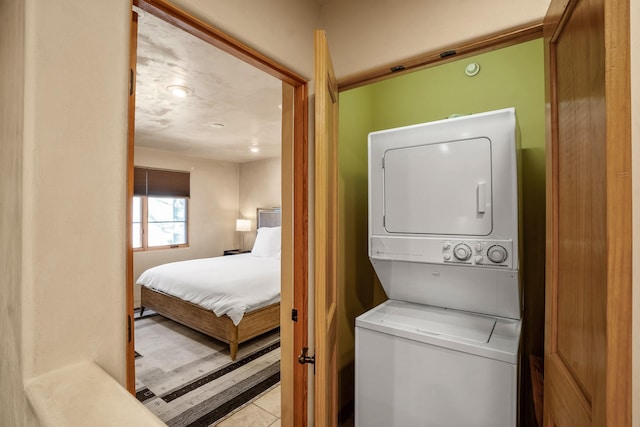 laundry area featuring stacked washer / drying machine