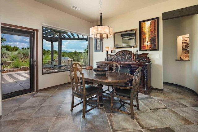 dining space with an inviting chandelier, baseboards, and visible vents