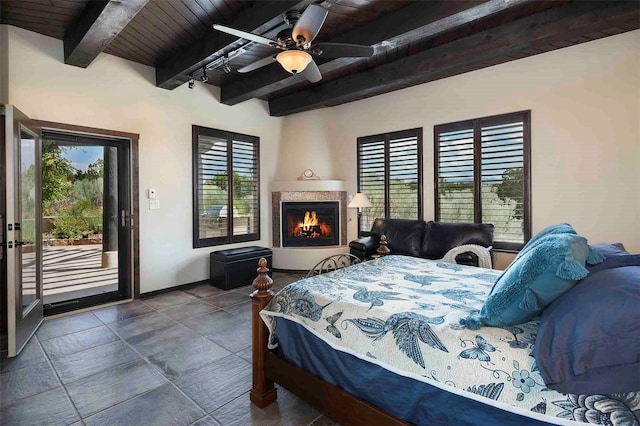 bedroom with beamed ceiling, multiple windows, wooden ceiling, and access to exterior