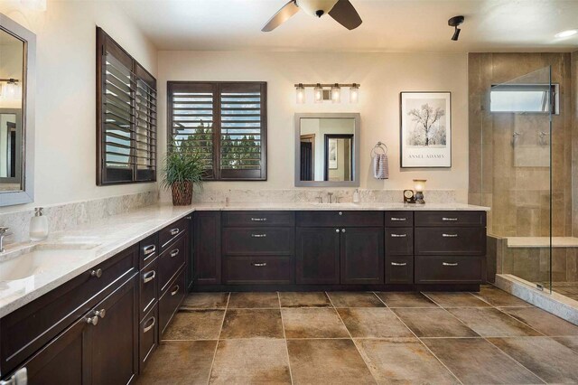 full bath with a tile shower, a ceiling fan, and vanity