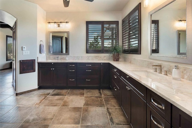 bathroom featuring ceiling fan and vanity