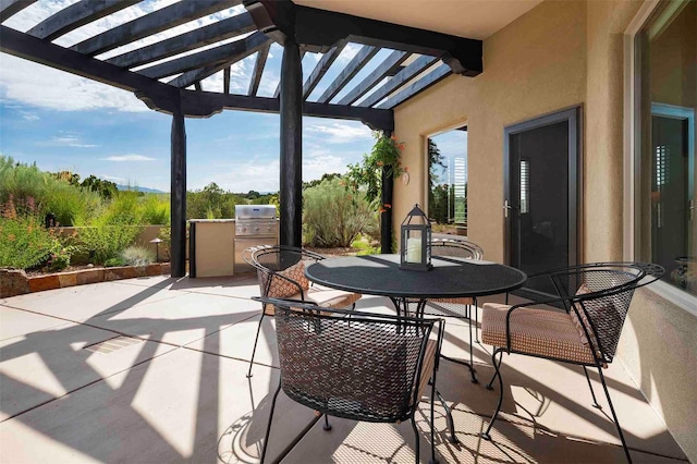 view of patio with outdoor dining space, area for grilling, and a pergola