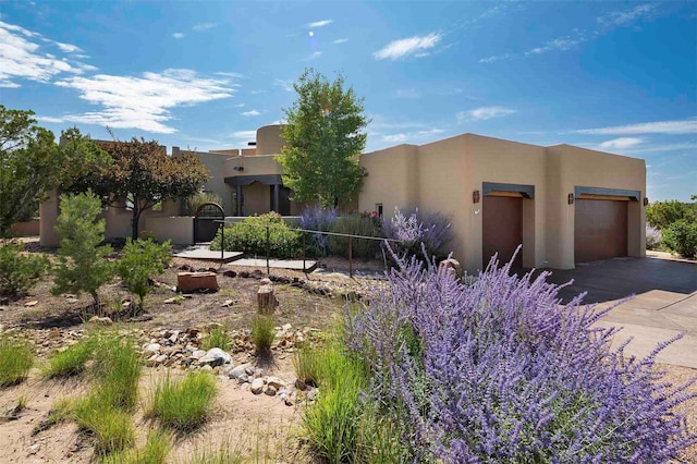 southwest-style home with an attached garage and stucco siding