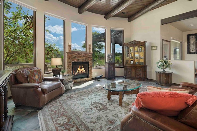 interior space featuring wooden ceiling, a fireplace, and beam ceiling