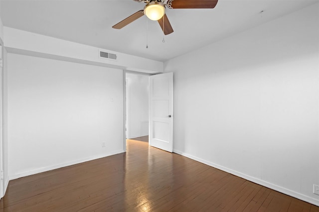 unfurnished room with dark hardwood / wood-style floors and ceiling fan