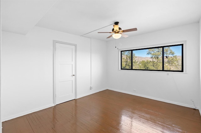 spare room featuring hardwood / wood-style floors and ceiling fan