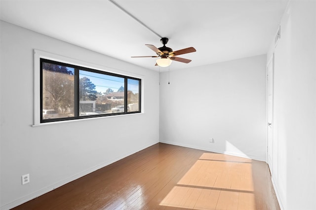 unfurnished room with hardwood / wood-style flooring and ceiling fan