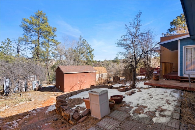 view of patio with a storage unit and a deck